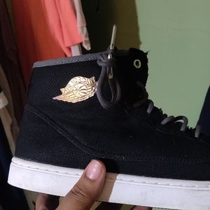 Black Air Jordans with silver crest on the ankles